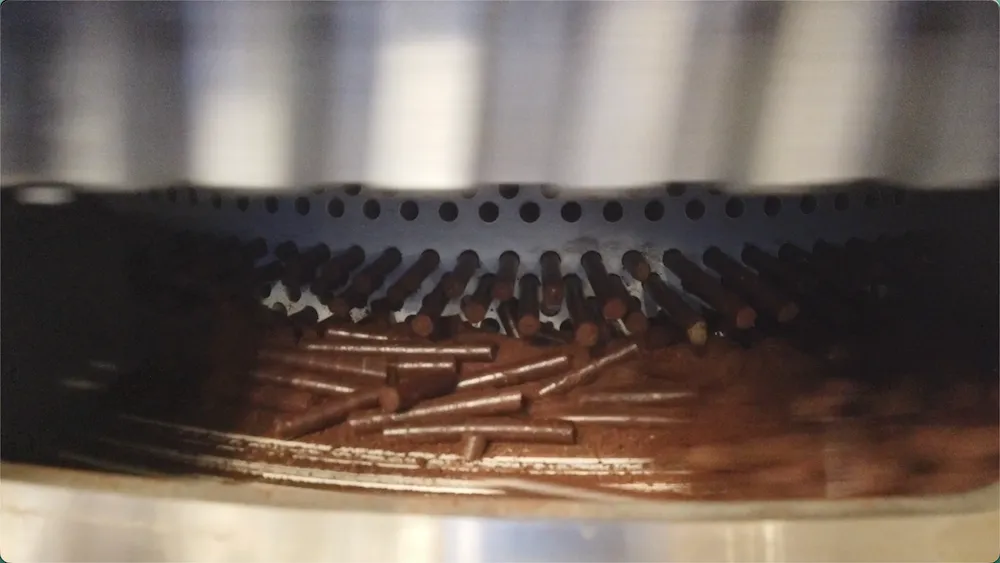 Material emerging from a wood pellet mill ring die